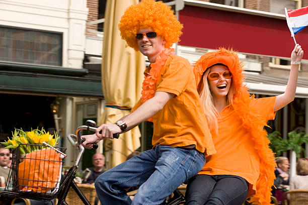 couple, orange, cycling, bike, amsterdam, local, dutch flag